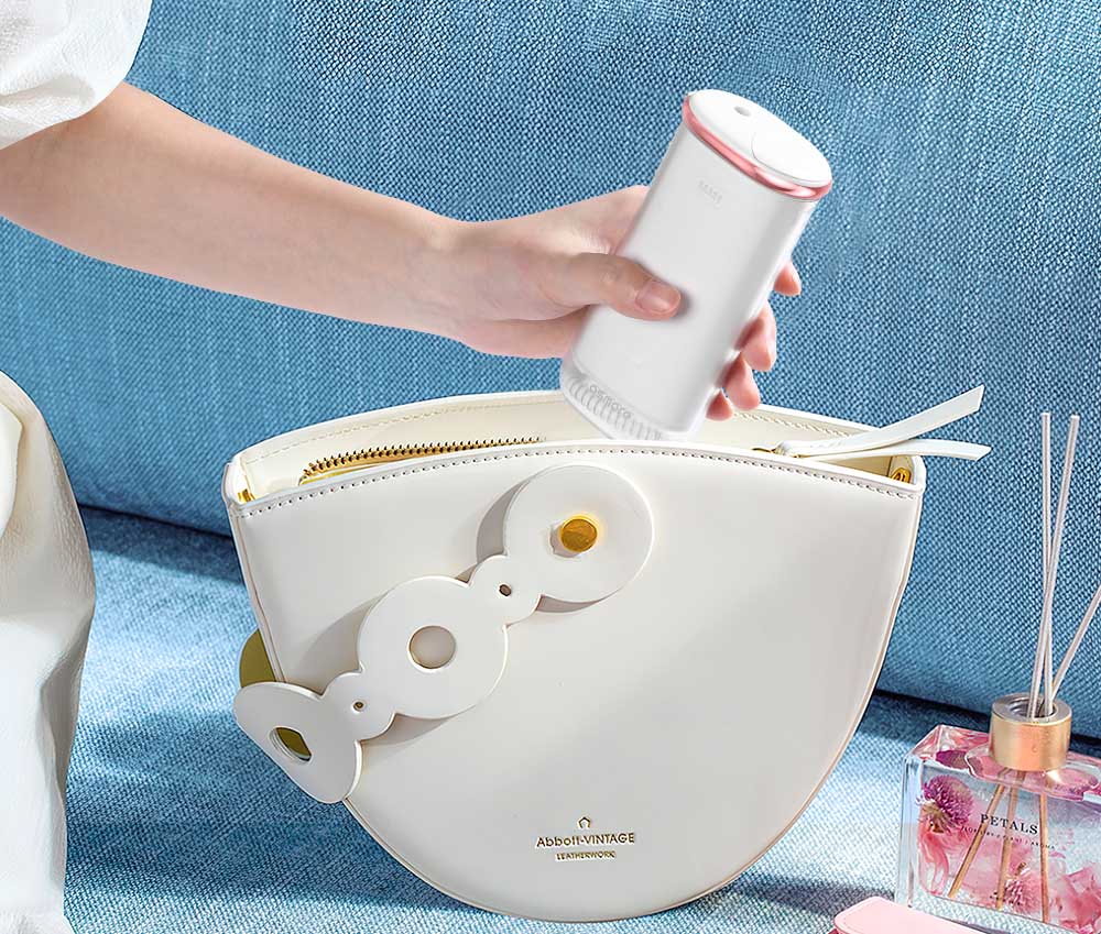 a model putting flosmore® CY1000 water flosser into her handbag